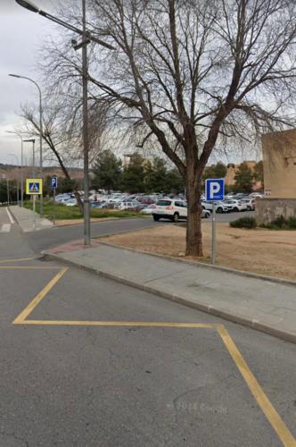 an empty street with a parking lot with a parking meter at Toledo Plaza in Toledo