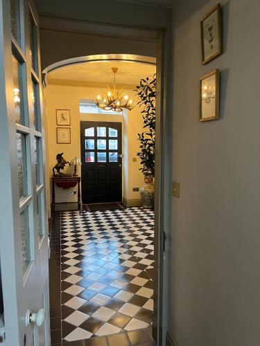 a hallway with a black and white checkered floor at Lewis Lodge - Stunning & Exclusive Luxury Home in the Heart of Ballater, Royal Deeside in Ballater