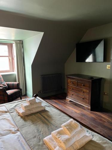 a bedroom with a bed with two towels on it at Lewis Lodge - Stunning & Exclusive Luxury Home in the Heart of Ballater, Royal Deeside in Ballater