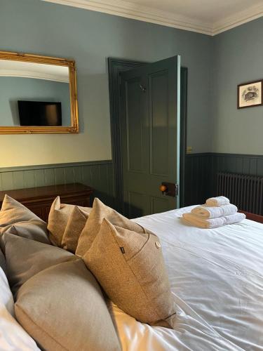 a bedroom with a bed with towels on it at Lewis Lodge - Stunning & Exclusive Luxury Home in the Heart of Ballater, Royal Deeside in Ballater