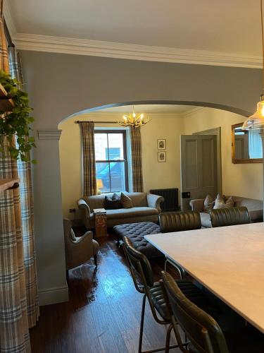 a living room with a couch and a table at Lewis Lodge - Stunning & Exclusive Luxury Home in the Heart of Ballater, Royal Deeside in Ballater