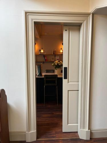 a door leading into a room with a kitchen at Lewis Lodge - Stunning & Exclusive Luxury Home in the Heart of Ballater, Royal Deeside in Ballater