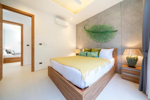 a bedroom with a bed with a green bowl on the wall at Villa private swimming pool and garden in Phuket Town