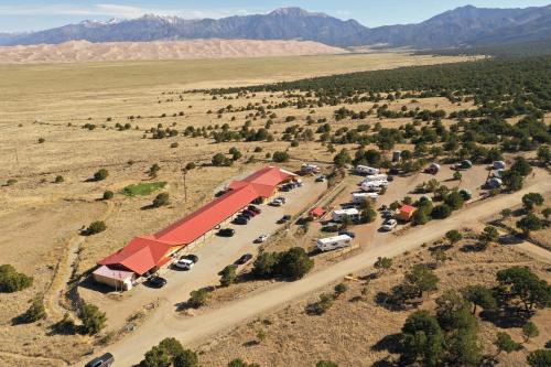 an aerial view of a parking lot with cars at Great Sand Dunes Lodge in Mosca