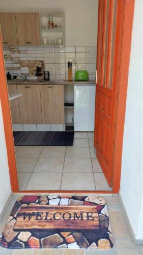 an open door to a kitchen with a rug on the floor at Lótusz Vendégház-Demjén in Demjén