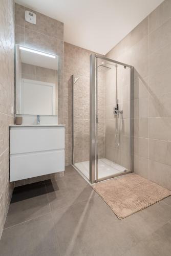 une salle de bain avec douche et lavabo dans l'établissement L'ensoleillé Superbe studio avec garage, à Caen