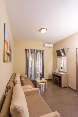 a living room with two couches and a desk at Sole A Mare in Neos Marmaras
