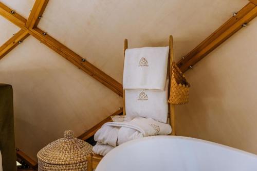 a room with a pile of towels in a attic at Kosmaj Zomes in Rovače