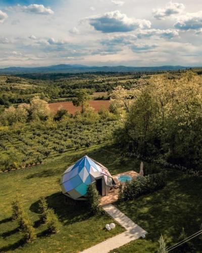 a blue and white tent in the middle of a field at Kosmaj Zomes in Rovače