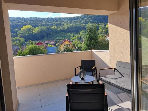 a balcony with a table and chairs and a view at Transilvania Memories in Sighişoara