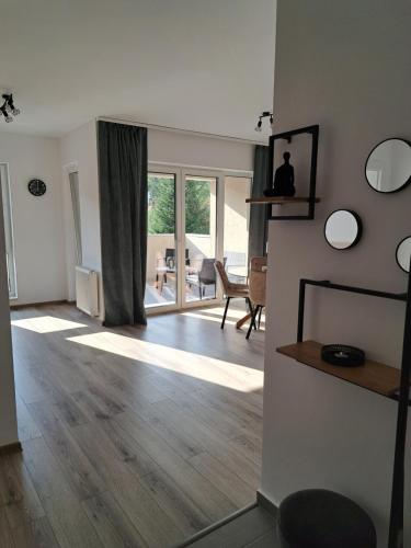a living room with a hardwood floor and sliding glass doors at Transilvania Memories in Sighişoara