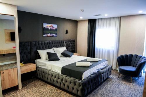 a hotel room with a bed and a chair at Siwiss İnn Experess in Ankara