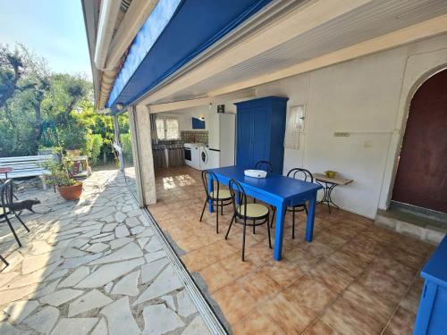 a blue table and chairs on a patio at La Genestière in Draguignan