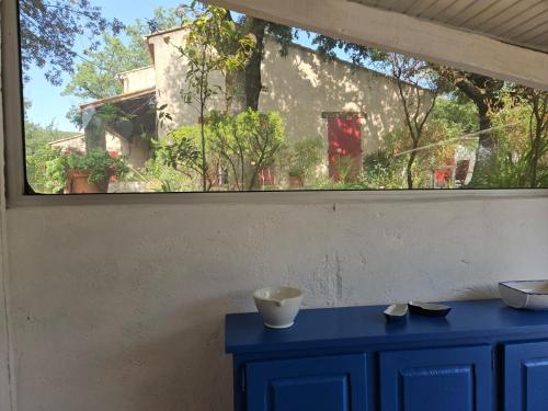 a window in a room with a blue cabinet at La Genestière in Draguignan