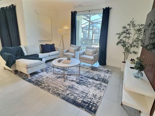a living room with a couch and a table at Storey lake 4BD/3BA BrandNew luxury pvt pool in Kissimmee