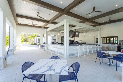 a patio with tables and chairs and a kitchen at Storey lake 4BD/3BA BrandNew luxury pvt pool in Kissimmee