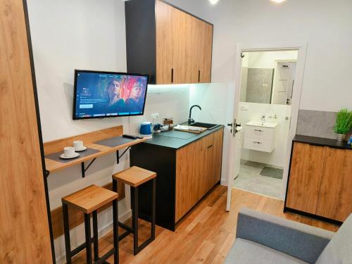 a kitchen with a desk and a television in a room at W sercu gór Sudeckich in Wałbrzych