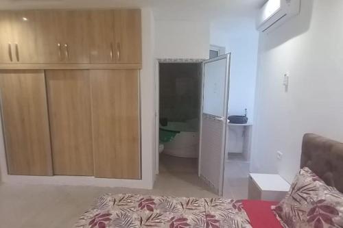 a living room with a bed and a large closet at Villa avec piscine in Korba