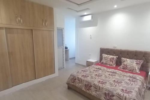 a bedroom with a large bed and a large cabinet at Villa avec piscine in Korba