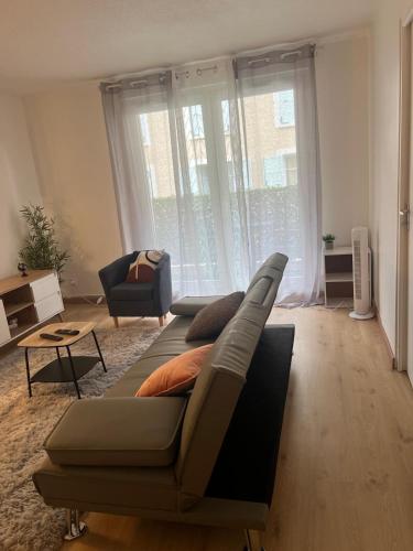 a living room with a couch and a chair at Champion suites in Sarcelles