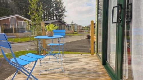 a table and chairs sitting on a porch at Foxgloves and Ivy in Cockermouth