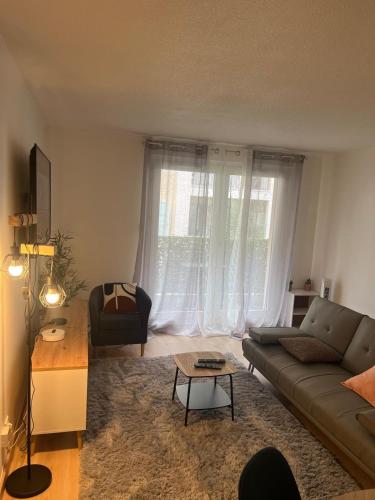 a living room with a couch and a table at Champion suites in Sarcelles