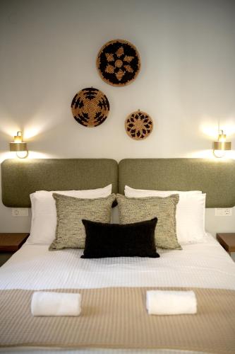 a bedroom with a bed with two plates on the wall at Eva's paradise Syros in Ermoupoli