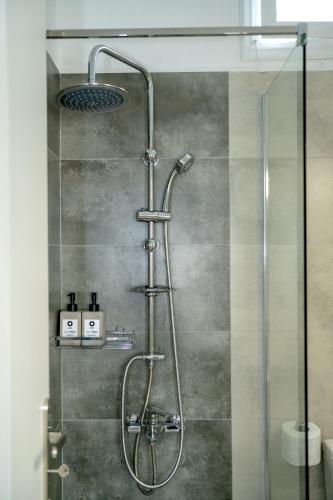a shower with a glass door in a bathroom at Eva's paradise Syros in Ermoupoli