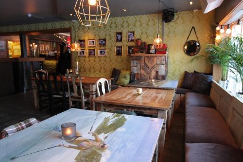 a restaurant with a table with a woman on it at Hemsedal Cafe Skiers Lodge in Hemsedal