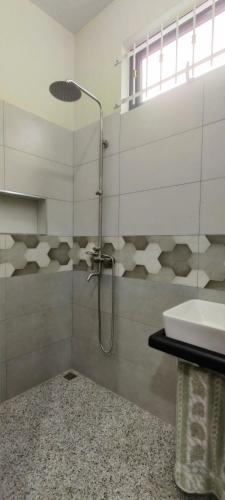 a bathroom with a shower and a sink at Tranquil Two-bed Retreat in Mahébourg