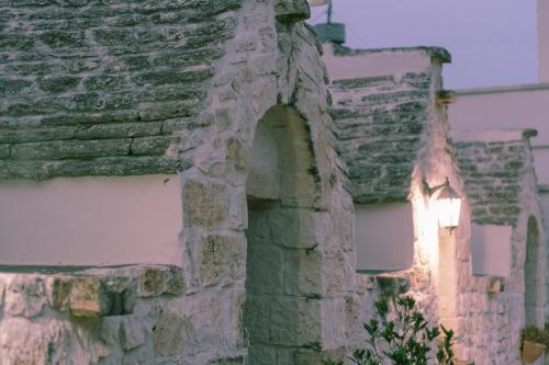 an old stone building with a light on it at Trullo Incanto in Ostuni