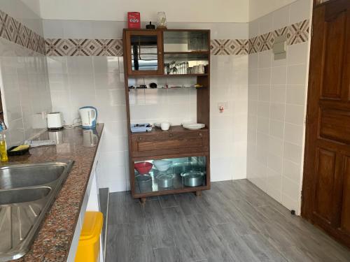 a kitchen with a sink and a counter top at Lions Home in Diani Beach