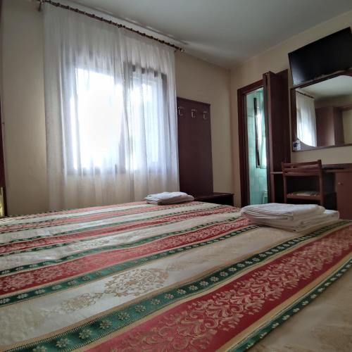 a large bed in a room with a window at Ponte Nuovo in Altissimo