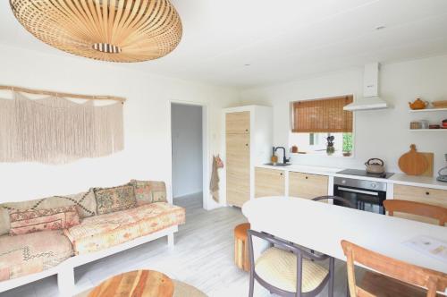 a living room with a couch and a table at Casita Ouddorp aan Zee in Ouddorp