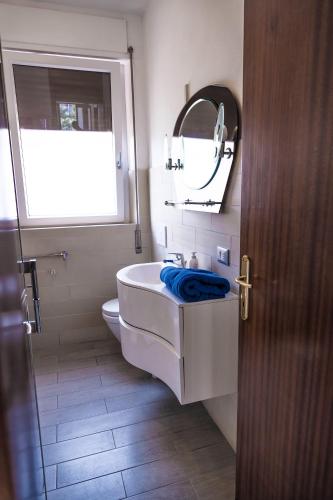 a bathroom with a tub and a sink and a mirror at Casa Vacanze - SportHoliday House Segusino-Valdobbiadene in Segusino