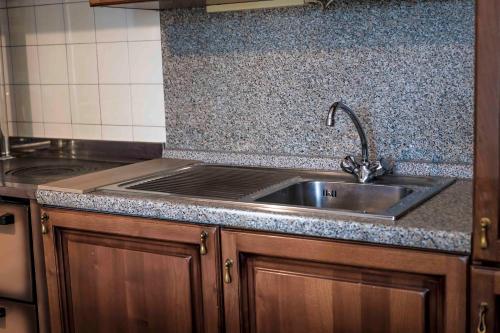 a kitchen with a sink and a counter top at Casa Vacanze - SportHoliday House Segusino-Valdobbiadene in Segusino