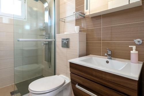a bathroom with a toilet and a sink and a shower at House Goran in Kolan