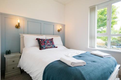 a bedroom with a bed with two towels on it at The Brambles Retreat in the Mournes in Annalong