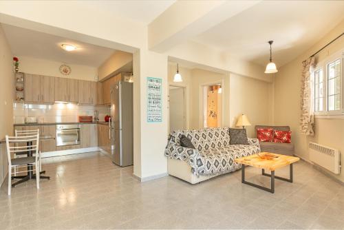 a living room with a couch and a table at Oskars Studios & Apartments in Lassi