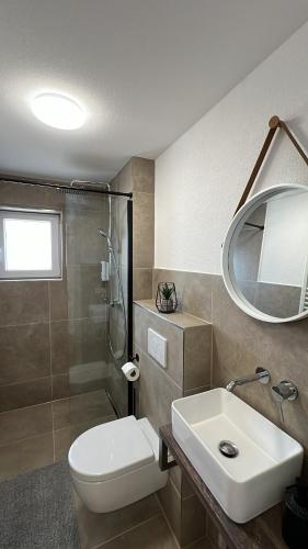 a bathroom with a toilet and a sink and a shower at Casa Estella in Rust