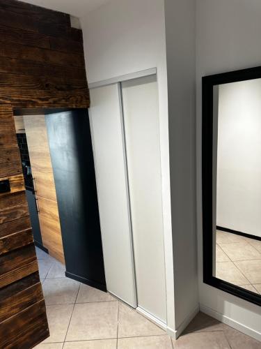 a room with three closets and a mirror at La Perle in Mers-les-Bains