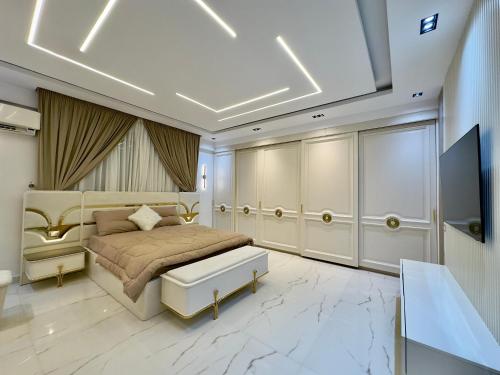 a bedroom with a king sized bed and a television at Heart of Al Mohandiseen in Cairo