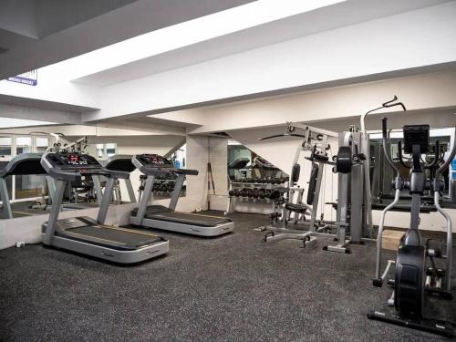 a gym with several tread machines in a room at SuiteDelux Oceanview Marbella 3BDR in Juan Pedro