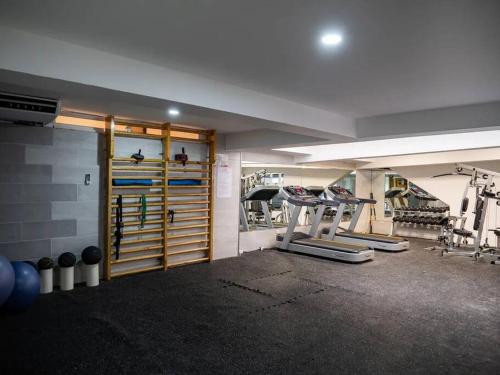 a room with a gym with weights and equipment at SuiteDelux Oceanview Marbella 3BDR in Juan Pedro
