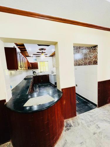 a large kitchen with a counter in a room at Bhurban Lodges in Murree