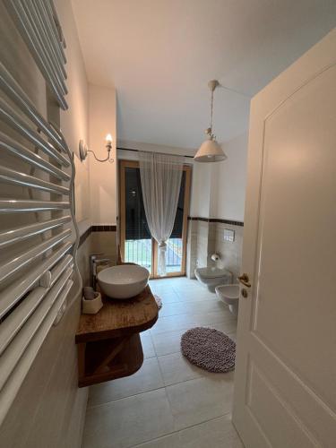a bathroom with a sink and a toilet in it at Casa delle Orchidee in Feltre