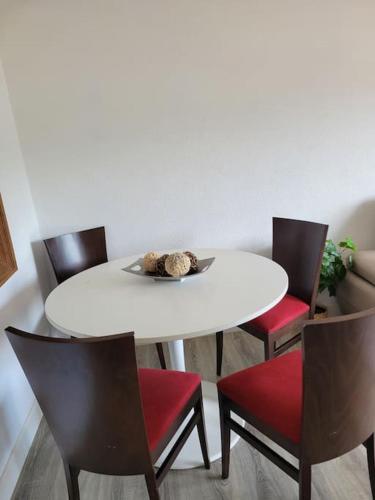 a white table with chairs and a teddy bear on it at APARTAMENTO ACOGEDOR CON BONITAS VISTAS. E-BI-609 in Bakio