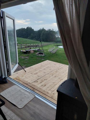 a wooden deck with a view of a yard at Pausa in Żegoty