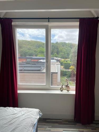 a bedroom window with a view of a building at Wijk aan Zee de Wilde Roos in Wijk aan Zee