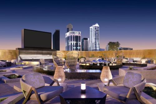a patio with chairs and a tv in a city at JW Marriott Hotel Riyadh in Riyadh